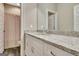Bright bathroom with a granite-topped vanity and a view into the shower at 234 Thyme Leaf Way, Locust Grove, GA 30248