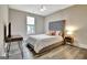 Bedroom with tufted headboard, wood floors, and a bright window at 234 Thyme Leaf Way, Locust Grove, GA 30248