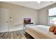 Bright bedroom with a flat-screen TV and a large window at 234 Thyme Leaf Way, Locust Grove, GA 30248