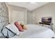 Bedroom featuring a gray tufted headboard and a mounted TV at 234 Thyme Leaf Way, Locust Grove, GA 30248