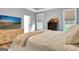 Comfortable bedroom with a light color scheme, a decorative dresser, and a TV with a beach scene at 234 Thyme Leaf Way, Locust Grove, GA 30248
