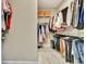 Well-organized walk-in closet featuring multiple shelves and hanging rods filled with clothes at 234 Thyme Leaf Way, Locust Grove, GA 30248