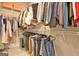 Organized walk-in closet featuring ample storage with hanging clothes and shelving with storage boxes at 234 Thyme Leaf Way, Locust Grove, GA 30248