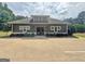 Charming clubhouse featuring gray siding, dormer windows, and attractive landscaping at 234 Thyme Leaf Way, Locust Grove, GA 30248
