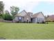 Charming home with a manicured lawn, enhanced by mature trees providing shade and privacy, with beautiful siding at 234 Thyme Leaf Way, Locust Grove, GA 30248