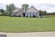Beautifully landscaped front yard enhances the curb appeal of this charming home with stone accents and complementary siding at 234 Thyme Leaf Way, Locust Grove, GA 30248