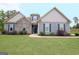 Charming home with stone and siding exterior, manicured lawn and well-maintained landscaping, creating a welcoming curb appeal at 234 Thyme Leaf Way, Locust Grove, GA 30248