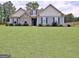 Attractive home featuring a well-manicured lawn and tasteful landscaping, enhancing its inviting curb appeal at 234 Thyme Leaf Way, Locust Grove, GA 30248