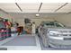 Spacious two-car garage with epoxy flooring and ample storage space with organized shelving at 234 Thyme Leaf Way, Locust Grove, GA 30248