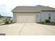 Attached garage with a driveway featuring manicured landscaping and exterior lighting for added appeal at 234 Thyme Leaf Way, Locust Grove, GA 30248