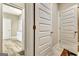 Bright hallway with marble-style tile and white paneled doors offers a clean and modern aesthetic at 234 Thyme Leaf Way, Locust Grove, GA 30248