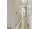 Long hallway with wood-look flooring and white doors providing access to other rooms at 234 Thyme Leaf Way, Locust Grove, GA 30248