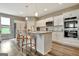 Bright kitchen features a large center island, stainless steel appliances, and white cabinets at 234 Thyme Leaf Way, Locust Grove, GA 30248