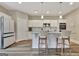 Kitchen features a center island with seating, stainless steel appliances, and white cabinets at 234 Thyme Leaf Way, Locust Grove, GA 30248