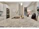 Kitchen island features a stainless steel sink and faucet along with ample granite countertop space at 234 Thyme Leaf Way, Locust Grove, GA 30248
