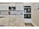 Close-up of kitchen featuring granite countertops, stainless steel appliances, and white subway tile backsplash at 234 Thyme Leaf Way, Locust Grove, GA 30248