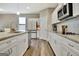 Bright kitchen featuring white cabinets, granite countertops, and stainless steel appliances at 234 Thyme Leaf Way, Locust Grove, GA 30248