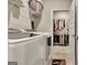 Functional laundry room with modern appliances, storage shelves, and closet at 234 Thyme Leaf Way, Locust Grove, GA 30248