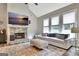Comfortable living room featuring a stone fireplace, a vaulted ceiling, and large windows at 234 Thyme Leaf Way, Locust Grove, GA 30248