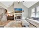 Inviting living room featuring a stone fireplace, vaulted ceiling, and an open view of the staircase at 234 Thyme Leaf Way, Locust Grove, GA 30248