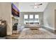 Bright living room featuring stone fireplace, large windows, and an inviting seating area at 234 Thyme Leaf Way, Locust Grove, GA 30248