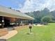 Outdoor pool area with covered pavilion, picnic tables, lounge chairs, and lush lawn at 234 Thyme Leaf Way, Locust Grove, GA 30248
