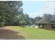 Scenic view of the outdoor pool area with stone fireplace pavilion and ample lounge seating at 234 Thyme Leaf Way, Locust Grove, GA 30248