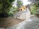 Charming split-level home with brick facade and a long driveway surrounded by mature trees at 2239 Nelms Sw Dr, Atlanta, GA 30315