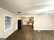 Open-concept living room with hardwood floors and view of the kitchen at 2239 Nelms Sw Dr, Atlanta, GA 30315