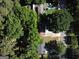 Aerial view of a home surrounded by mature trees in a residential neighborhood at 1150 Goldsmith Rd, Stone Mountain, GA 30083