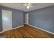 Bedroom with wood flooring, ceiling fan and two doors at 1150 Goldsmith Rd, Stone Mountain, GA 30083