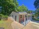 Brick and siding exterior with a covered porch supported by decorative columns at 1150 Goldsmith Rd, Stone Mountain, GA 30083