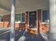 Inviting front porch with brick columns, a stylish door, and a decorative exterior light at 1150 Goldsmith Rd, Stone Mountain, GA 30083