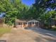 Charming brick home featuring a covered front porch and ample concrete driveway at 1150 Goldsmith Rd, Stone Mountain, GA 30083