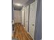 Hallway with doors along the wall and wood flooring at 1150 Goldsmith Rd, Stone Mountain, GA 30083