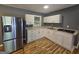 Updated kitchen featuring white cabinets, granite countertops, and stainless steel appliances at 1150 Goldsmith Rd, Stone Mountain, GA 30083