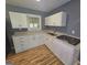 Modern kitchen with white cabinets, granite countertops, and a stainless steel sink at 1150 Goldsmith Rd, Stone Mountain, GA 30083