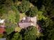 Aerial view featuring a brick home nicely nestled in a wooded area at 1655 Stacia Dr, Covington, GA 30016