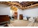 Basement space with unfinished ceiling, patterned rug, and diverse furniture, ideal for storage or recreation at 1655 Stacia Dr, Covington, GA 30016
