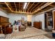 Basement with unfinished ceiling, patterned rug, and various furniture pieces, suitable for flexible use at 1655 Stacia Dr, Covington, GA 30016