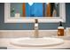 Bathroom vanity with white sink, silver faucet, and neutral countertop, complemented by blue walls and white trim at 1655 Stacia Dr, Covington, GA 30016