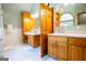 This bathroom has dual sinks, wooden cabinets, tile floors, and neutral walls for a clean, classic look at 1655 Stacia Dr, Covington, GA 30016