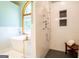 Bright bathroom features a soaking tub and tile shower with dual shower heads and black honeycomb tile flooring at 1655 Stacia Dr, Covington, GA 30016