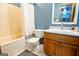 Functional bathroom with a tiled shower, a wooden vanity, and coordinating fixtures for a pleasant space at 1655 Stacia Dr, Covington, GA 30016