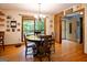 Inviting dining room featuring hardwood floors, a chandelier, and a large window with natural light at 1655 Stacia Dr, Covington, GA 30016