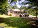 Beautiful brick home nestled among mature trees with a well-manicured lawn at 1655 Stacia Dr, Covington, GA 30016
