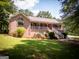 Charming brick home features a lovely front porch, well-manicured lawn, and inviting curb appeal at 1655 Stacia Dr, Covington, GA 30016