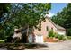 Side view of a brick house featuring an attached garage and well-kept landscaping at 1655 Stacia Dr, Covington, GA 30016