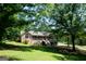 Well-maintained brick home with a lush green lawn and mature trees at 1655 Stacia Dr, Covington, GA 30016