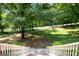A view from the porch of the property's front yard, showcasing mature trees, and a long driveway at 1655 Stacia Dr, Covington, GA 30016